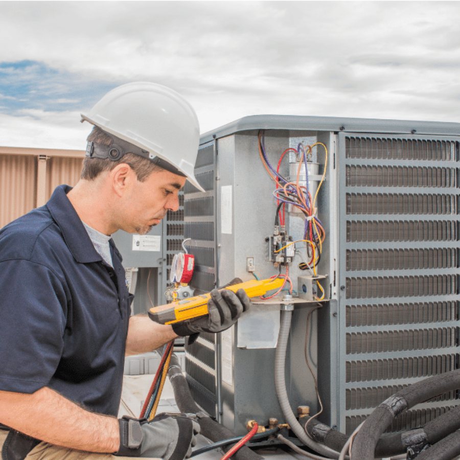 Owen Sound Heating & Cooling technician servicing a furnace in a Grey County home